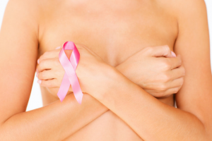 Woman with pink ribbon for breast cancer awareness month