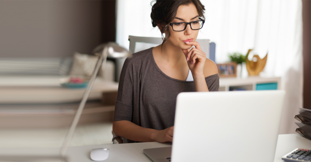 Brunette woman research Ultherapy on her computer.