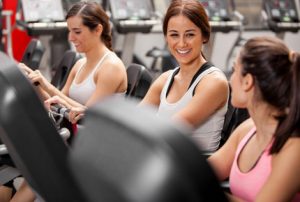 Beautiful Women on Exercise Machines at Gym