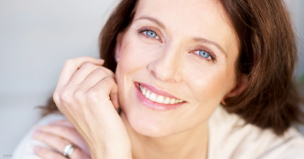 A woman smiles because of the happiness her facelift has brought her.