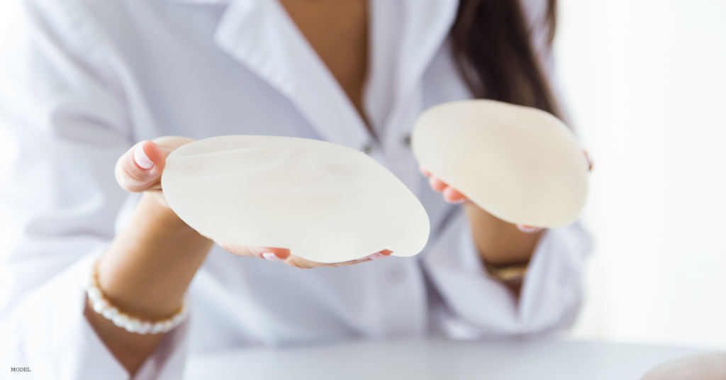 Doctor in Eugene, OR holding breast implants to explain safety