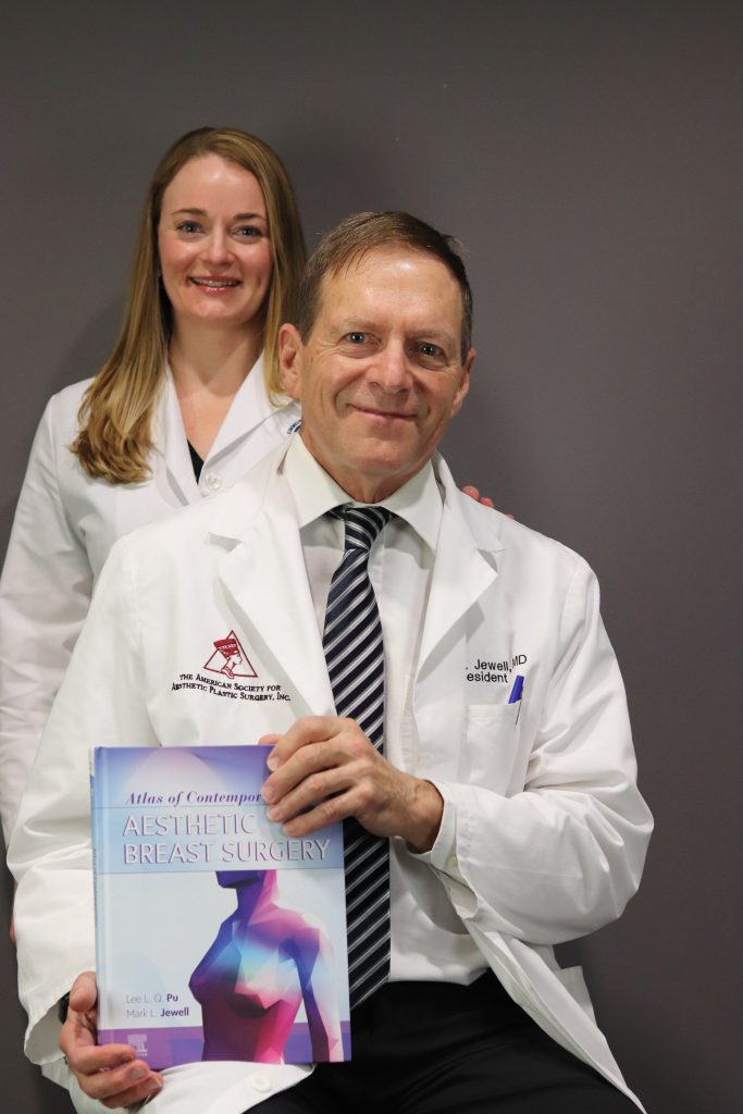 Dr. Jewell holding book