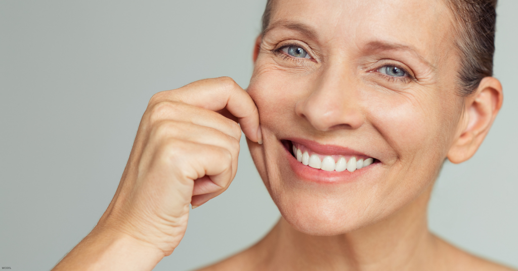 A woman poses after getting a med spa treatment.