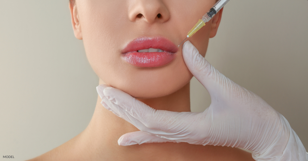 A woman getting lip injections (model)