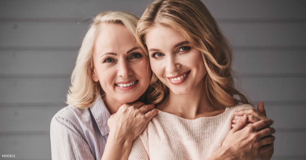 A mom and daughter hugging (model)