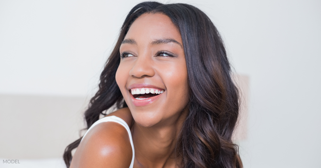 A woman smiling and looking away (model)