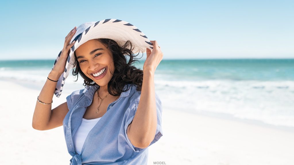 Woman smiling in sun hat (model)